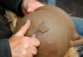 A professional potter creating a replica of a Medieval cooking pot