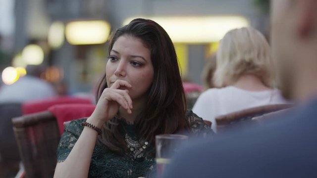 Close up slow motion shot of frustrated woman talking at restaurant / Berlin, Germany