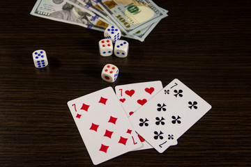 Playing cards, dice and dollars on a table