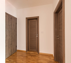 Wooden doors in new empty hall