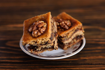 appetizing baklava with nuts and honey closeup on a wooden background