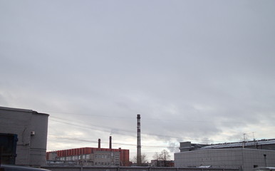 Obraz premium sky, fences, pipes in the industrial city quarter