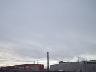 Obraz premium sky, fences, pipes in the industrial city quarter