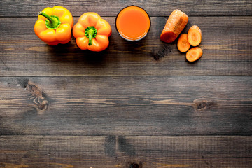 Orange detox beverage with paprica and carrot on dark wooden background top view copyspace
