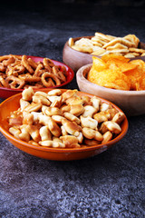 Salty snacks. Pretzels, chips, crackers in wooden bowls