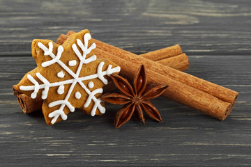 Spices on wooden background. Cinnamon sticks, anise and gingerbread.