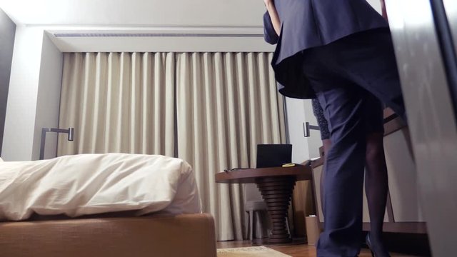 The concept of prostitution, theft. A brunette woman makes a businessman drunk and steals money at a hotel. 4k
