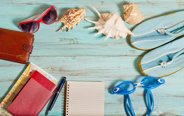 Accessories for travel on a wooden background, the concept of vacation and recreation at sea.