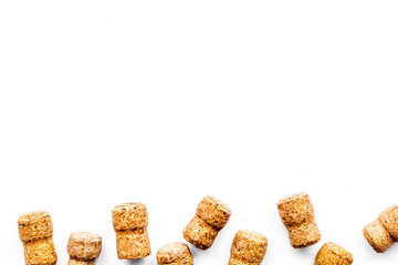 Wine bottle corks pattern on white background top view copyspace. New Year celebration concept