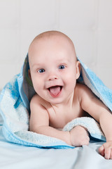 Newborn child dressed in a blue towel