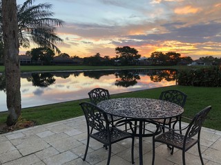 iron patio table and sunset in the water