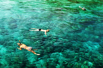 Tourists are engaged in snorkeling in the open sea. Holidays in the seaside resort.