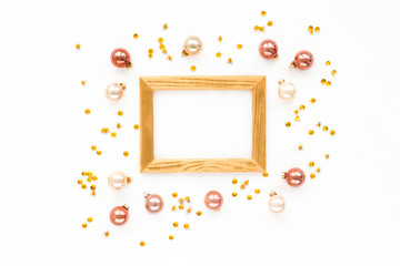 Christmas frame, golden clips, pink balls on white background, flat lay, top view