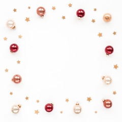 Fototapeta na wymiar Christmas pastel, red, pearl bells, golden stars on white background, top view, flat lay