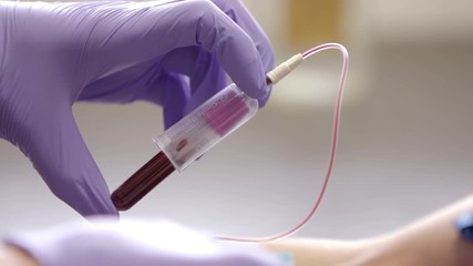 Completing blood draw. - Powered by Adobe