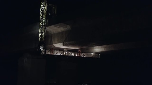 Structural Engineers Working at Night on a Concrete Bridge Inspecting for Cracks and Structural Damage