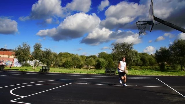 Basketball player working out in playground on a cloudy day