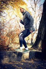 Fototapeta premium Jumping squats in nature. Man exercise.