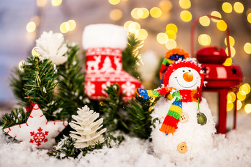 Christmas decoration on a wooden background with snowman, snow and  lights