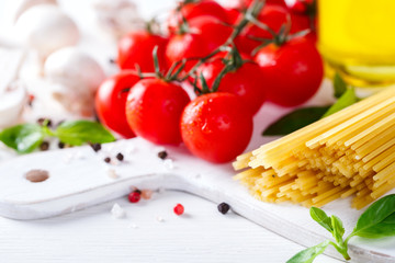 Pasta Spaghetti with ingredients for cooking pasta on a white background.Copy space for Text. selective focus.