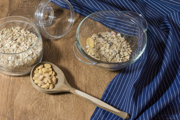 Muesli, granola, cereal and nuts in a glass container on a wooden table. Rustic food.