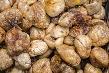 Close up top view dried dried figs. Background of oriental treats texture.