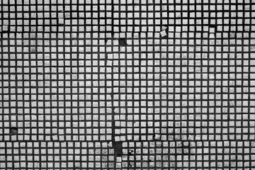 Black and white background of an old mosaic wall.