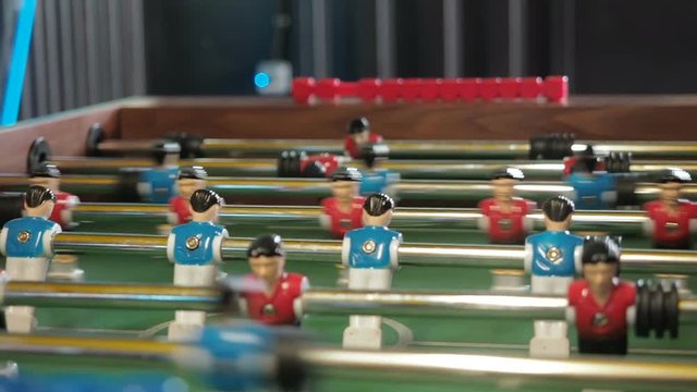 Active people playing foosball. table soccer plaers. Friends play together table football