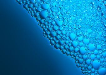 Bubbles on water surface with blue background