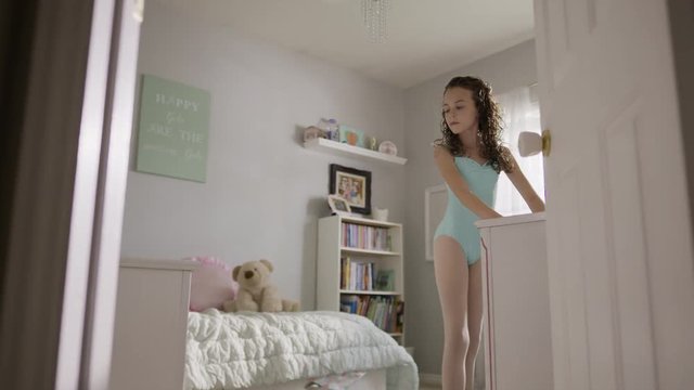 Medium slow motion shot of girl practicing ballet in bedroom / Provo, Utah, United States