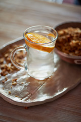 Healthy Breakfast of Champions. Muesli , a glass of water with a slice of orange. Ceramic handmade