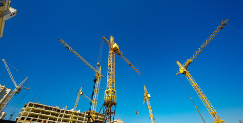 Large construction cranes. High and heavy construction machinery.