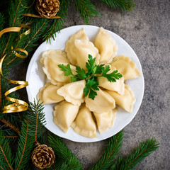 Christmas dumplings with decoration on a grey board. Top view.