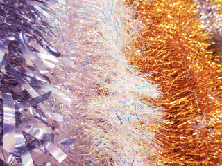 A lot of Christmas tinsel. Color festive Christmas background.
