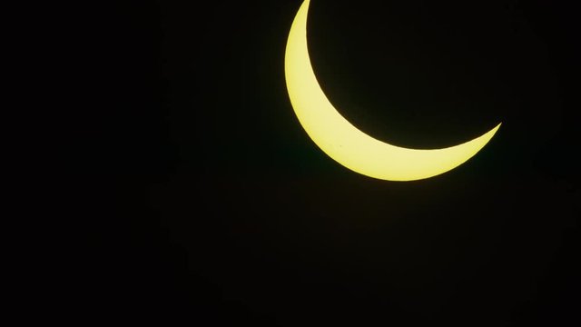 Panning shot of partial solar eclipse / Driggs, Idaho, United States