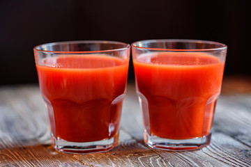 Glass of tomato juice with fresh tomatoes