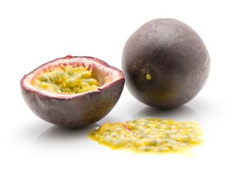 Passion fruit one whole one half with flesh isolated on white background.