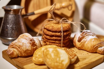 Fresh pastries for Breakfast. Oatmeal cookies, tied with jute rope, and pancakes . Rustic retro style
