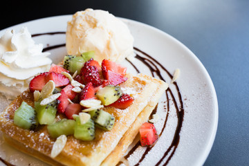 Waffles with fresh berries, whipped cream and ice cream