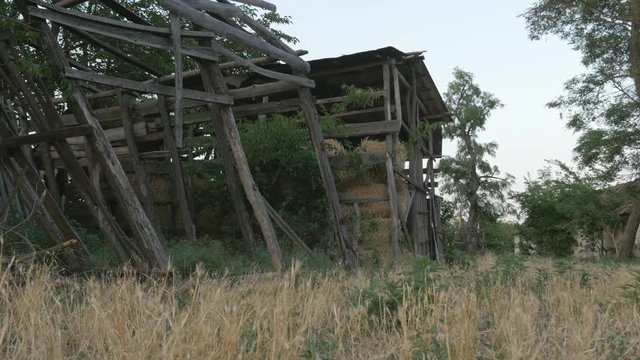 Wooden old barn for storage of hay in the village, nearby is the old hayloft unusable
