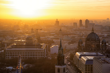 Beautiful panoramic aerial view over Berlin (Berlin Cathedral - Berliner Dom, City Palace - Stadtschloss, Potsdamer Platz, Bundestag - Reichstag) with romantic colorful sunset. © indigo641