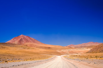 Sandy and gravel desert road through Altiplano