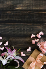 Marshmallow hearts, love letter and flowers on an old wooden background