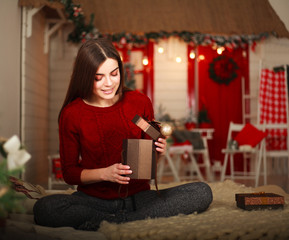 Woman with presents on background of Christmas tree and new year decorations