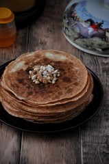 On the table, Russian thin pancakes with honey and nuts