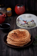 On the table, Russian thin pancakes with honey and nuts
