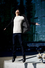 A young man with dark hair and eyes jumping. The feeling of freedom. Lifestyle. High growth.