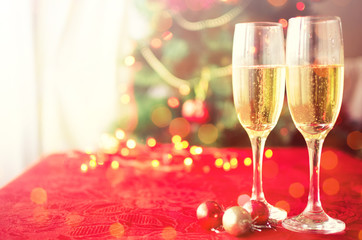 Two glasses of champagne near beautiful christmas tree