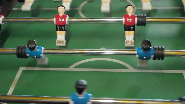 figures of footballers move left and right people playing foosball. table soccer plaers. table football soccer game kicker close up