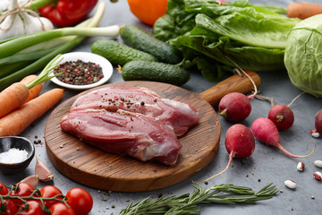 Raw duck fillet steak and fresh vegetables